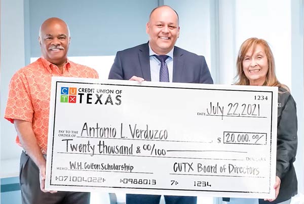 DISD Principal holding the big check for the William H. Cotton scholarship, one of the annual Dallas Scholarships from CUTX